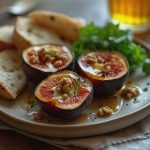 Three sliced figs topped with honey, walnuts, and herbs on a plate with bread and salad.